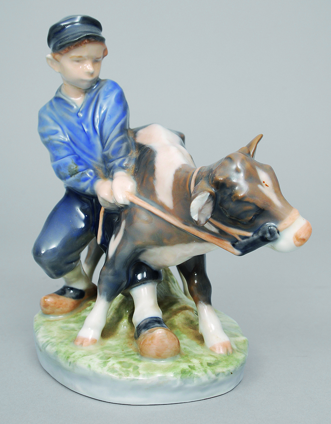 A figure of a boy with a cow