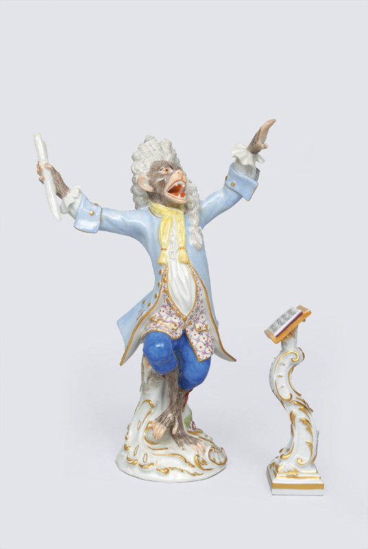 A figurine "chief conductor" of serial "music playing monkeys"