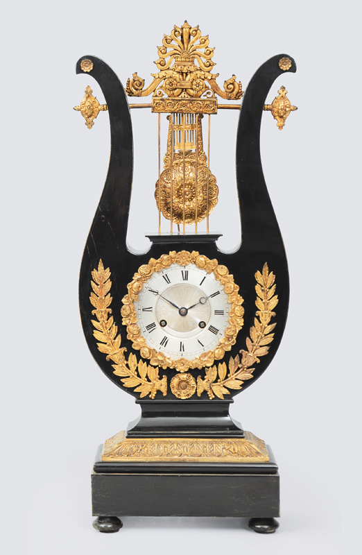 An Empire mantle clock in the shape of a lyra