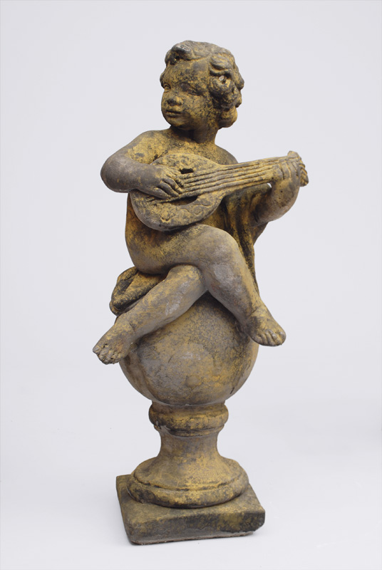 A large stone sculpture "A putto making music"