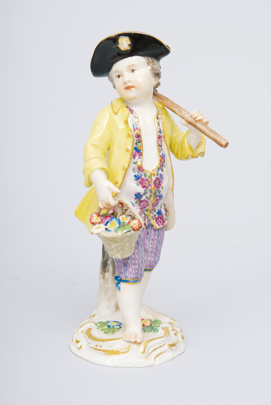 A figurine "Gardener"s child with hoe and flower basket