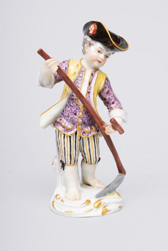 A figurine "Gardener"s child with scythe"