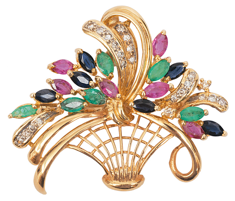 A flower brooch with sapphires, emerads and rubies