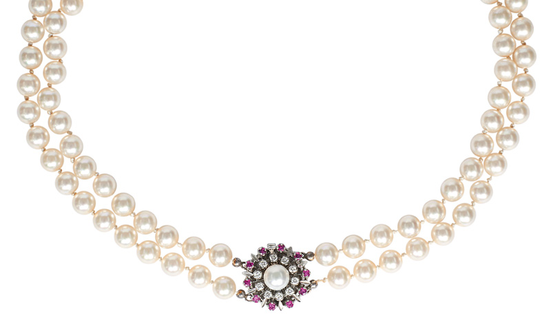A pearl necklace with a diamond ruby clasp