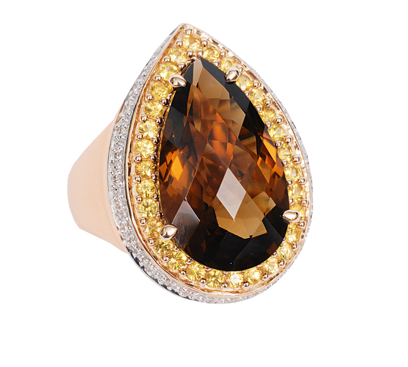 A smoky quartz ring with diamonds and yellow sapphires