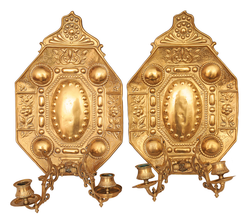 A pair of wall lights with blossom decoration