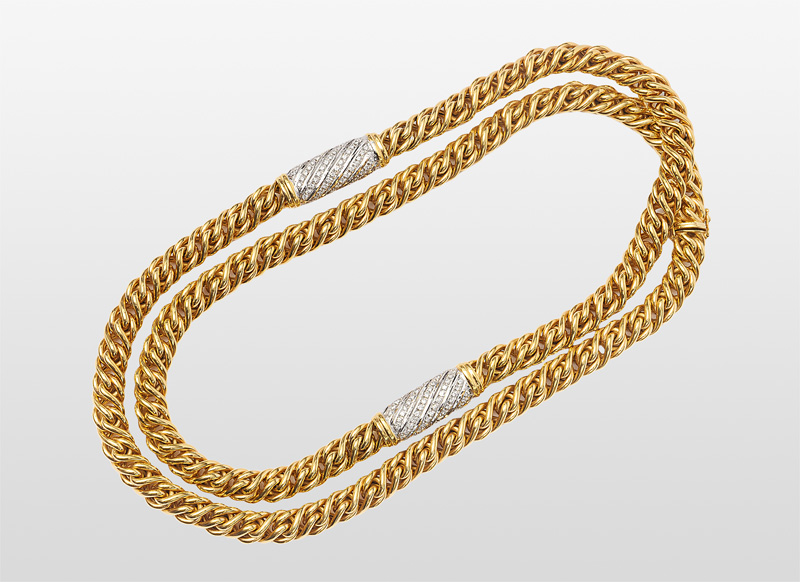 A long golden necklace with diamonds
