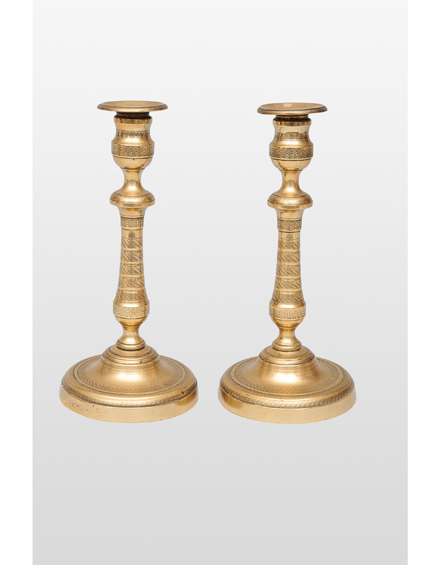 A pair of classical brass table candle holders