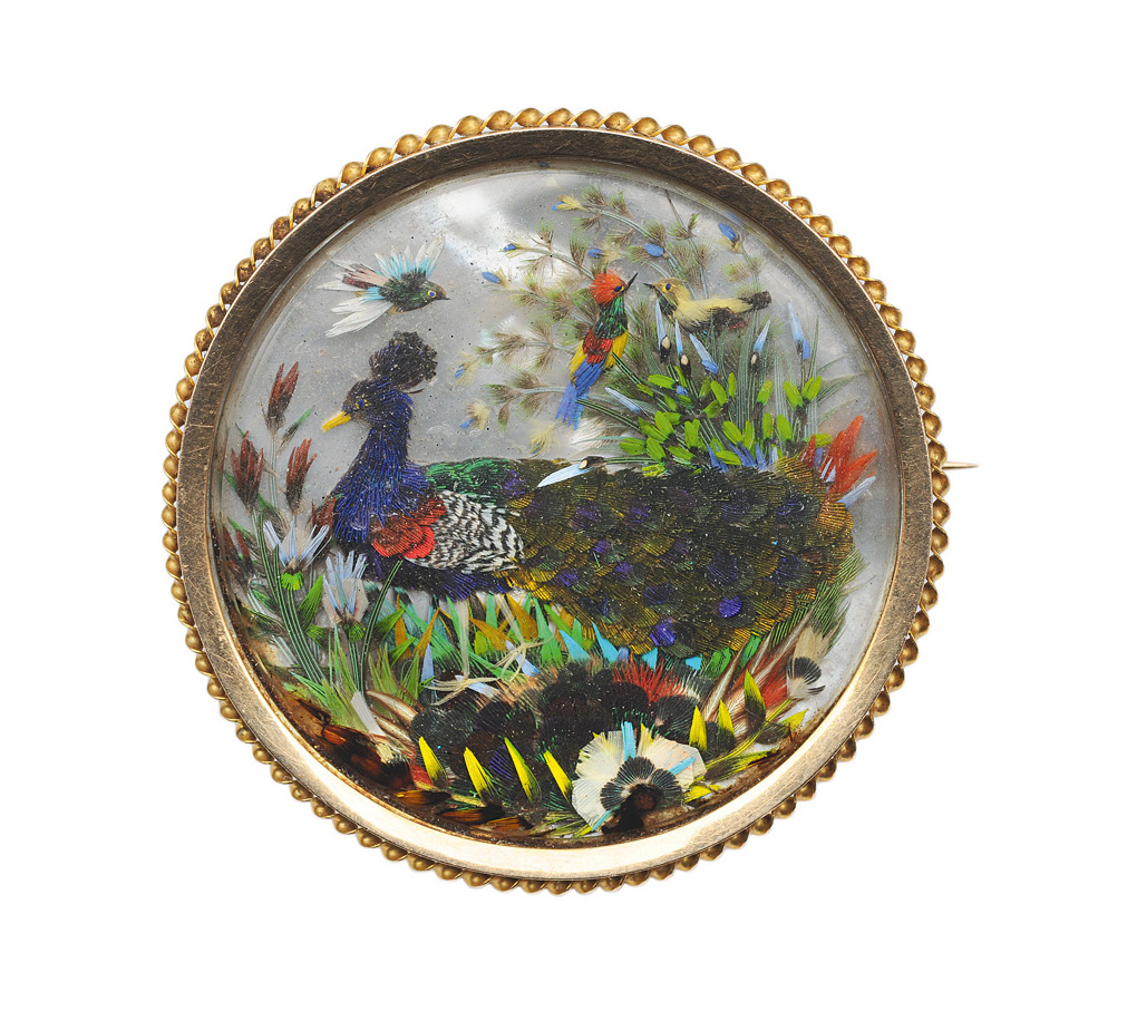 A brooch with bird-ornaments on mother-of-pearl