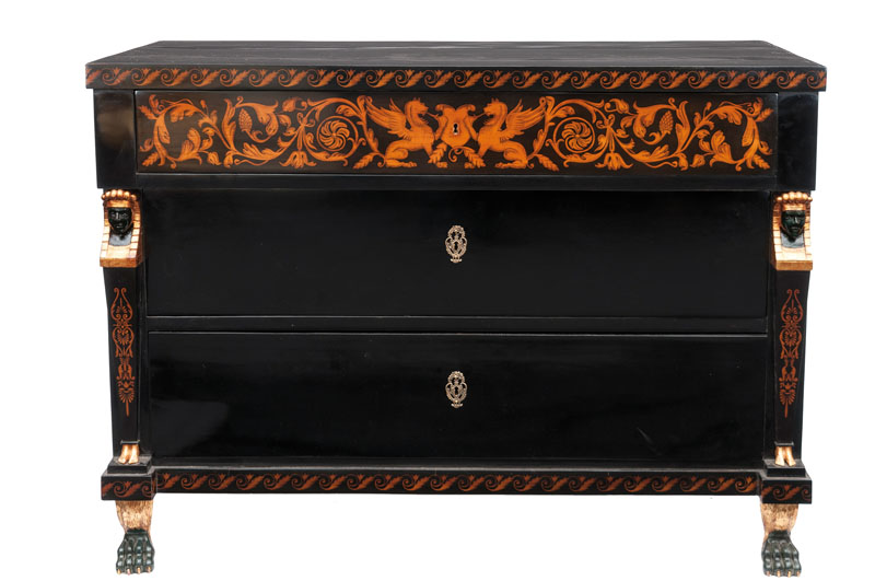 An elegant black lacquered chest of drawers with caryatid pilaster