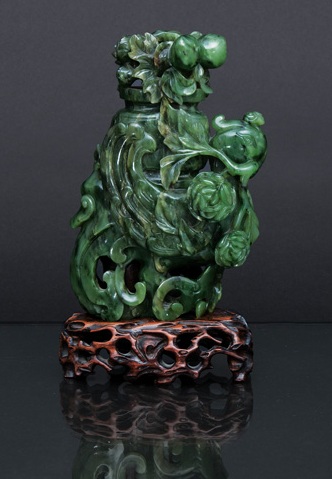 A spinach green jade vase in the shape of a phoenix