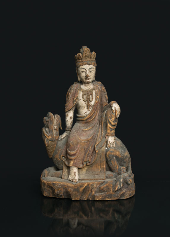 A tall wooden figure 'Guanyin on a lion'