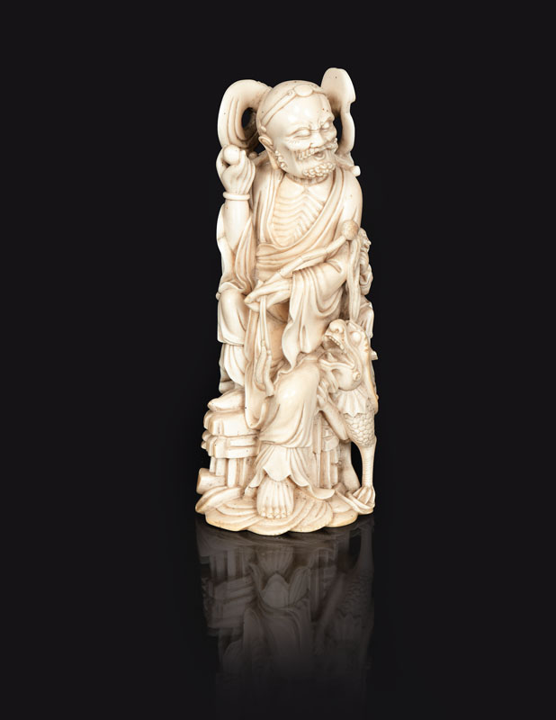 An ivory figure 'Luohan taming a dragon'
