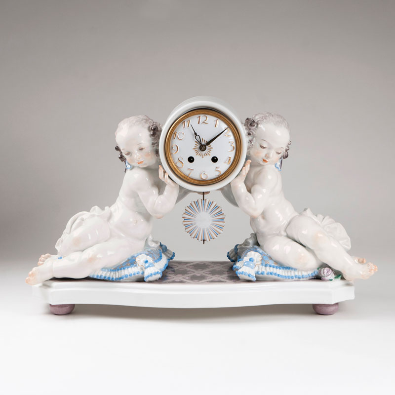 A large porcelain clock with a pair of putti