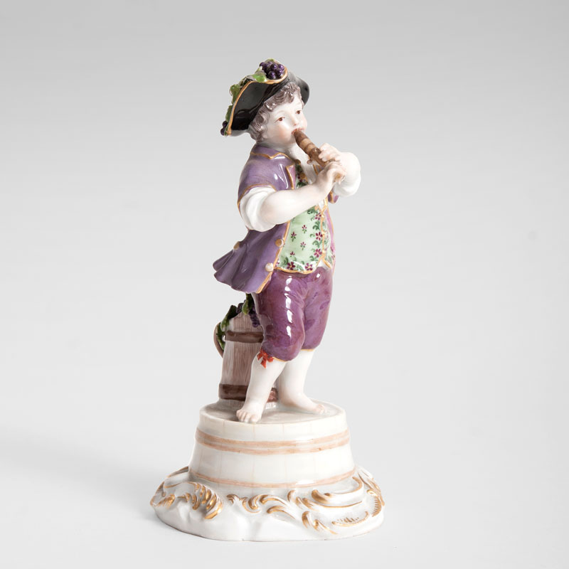 A porcelain figure 'gardener child playing the flute'