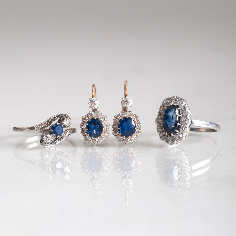 A pair of saphire diamond earrings and two sapphire diamond rings