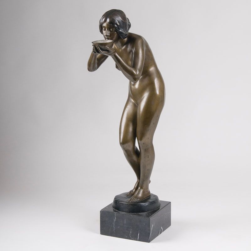 A tall bronze figure 'Drinking female nude'
