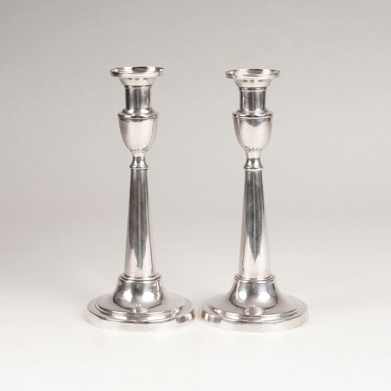 A pair of candle sticks in a classical style