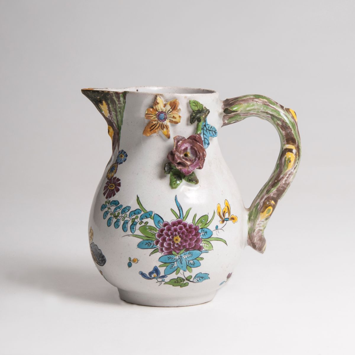 A faience jug with branch handle