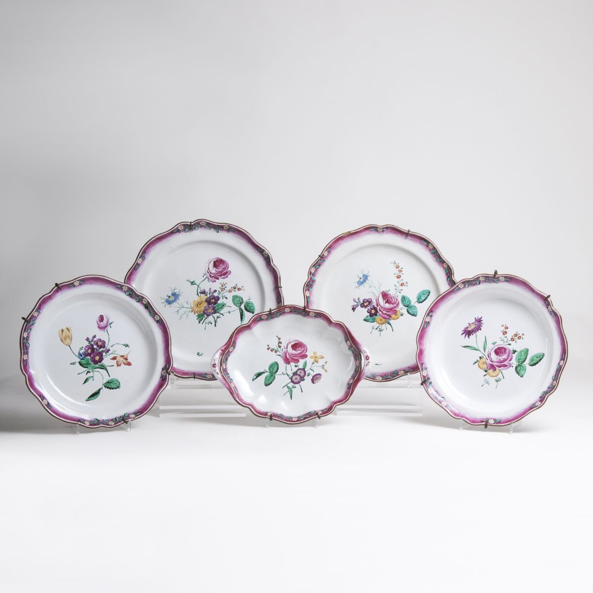A rare set of four faience plates and an oval dish