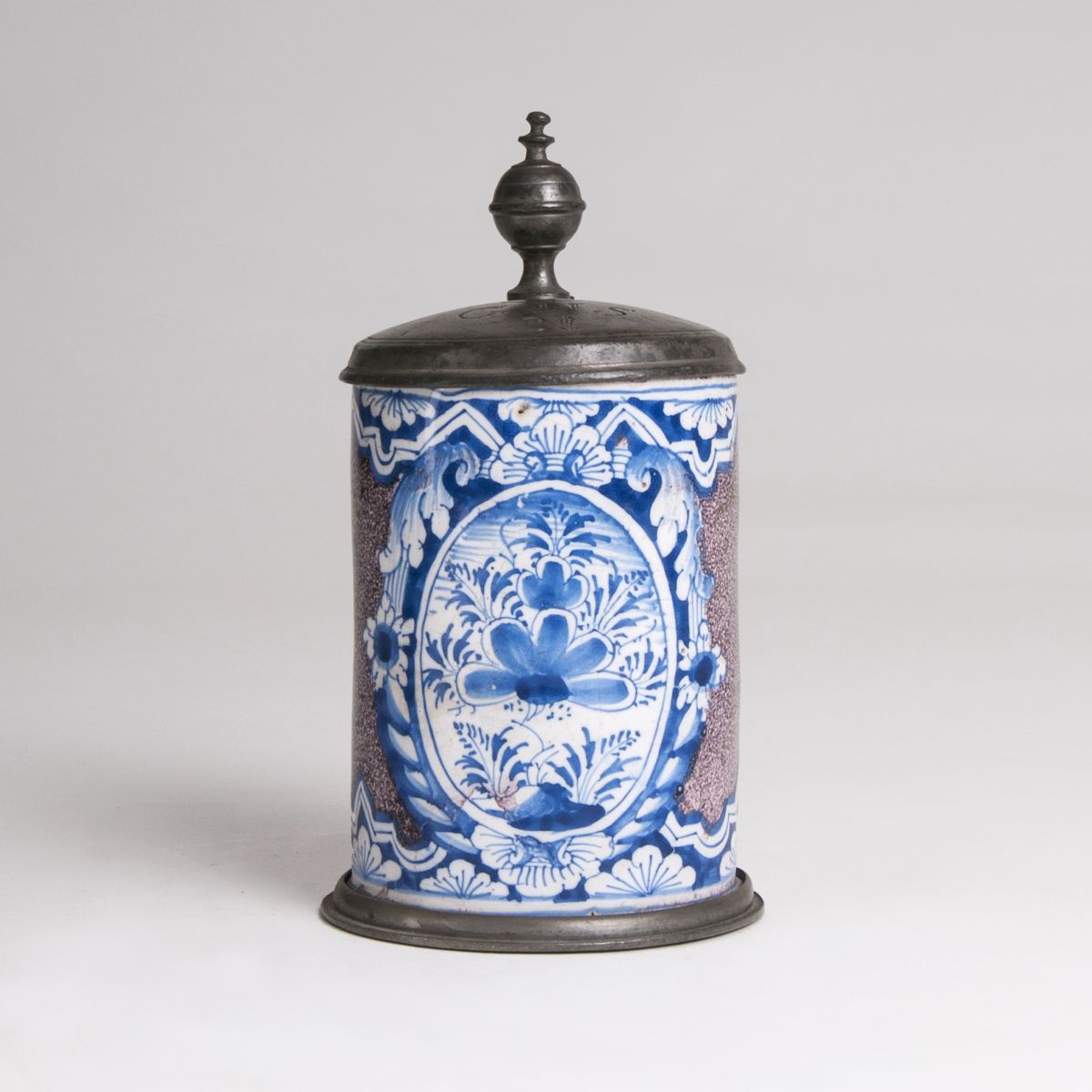 A small faience tankard with blue painting