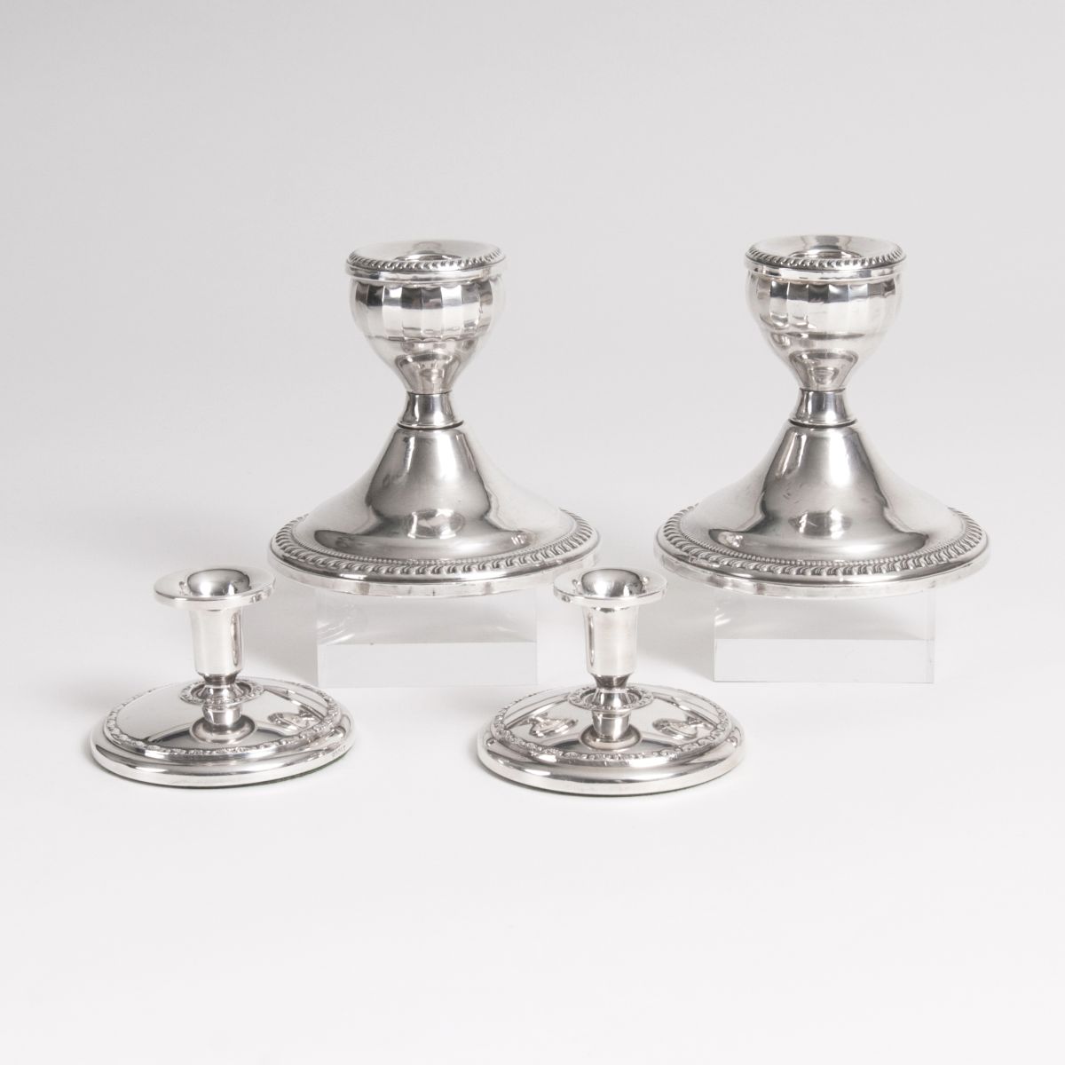 Two pairs of small table candle holders