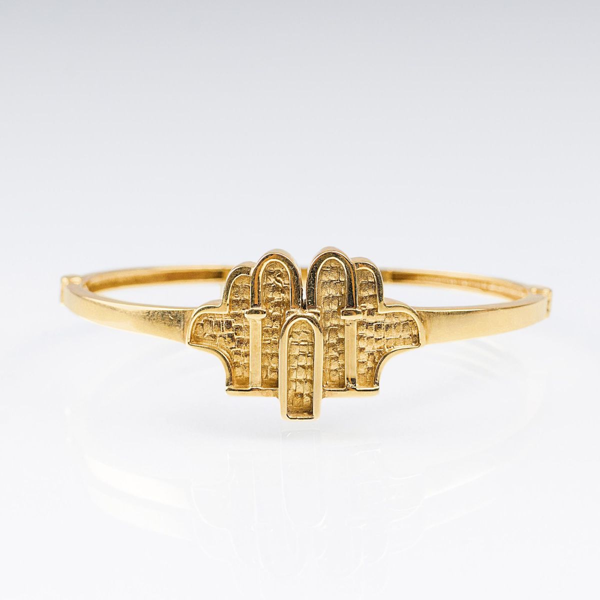 A Gold Bangle Bracelet with temples motive