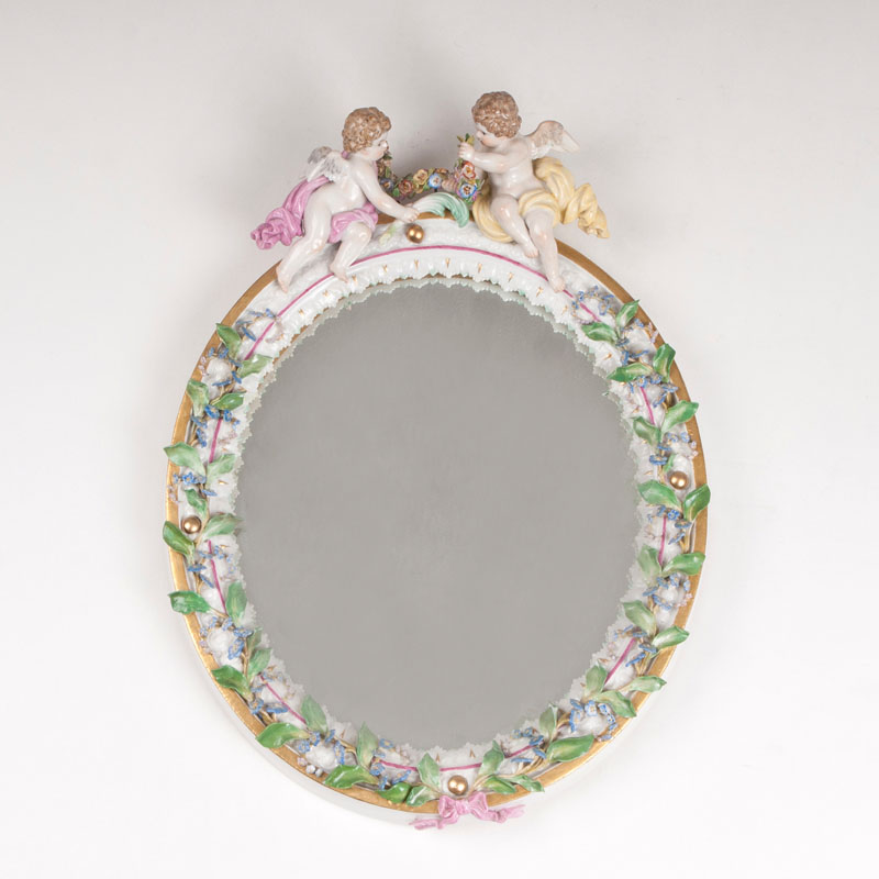 A small porcelain mirror with couple of angels