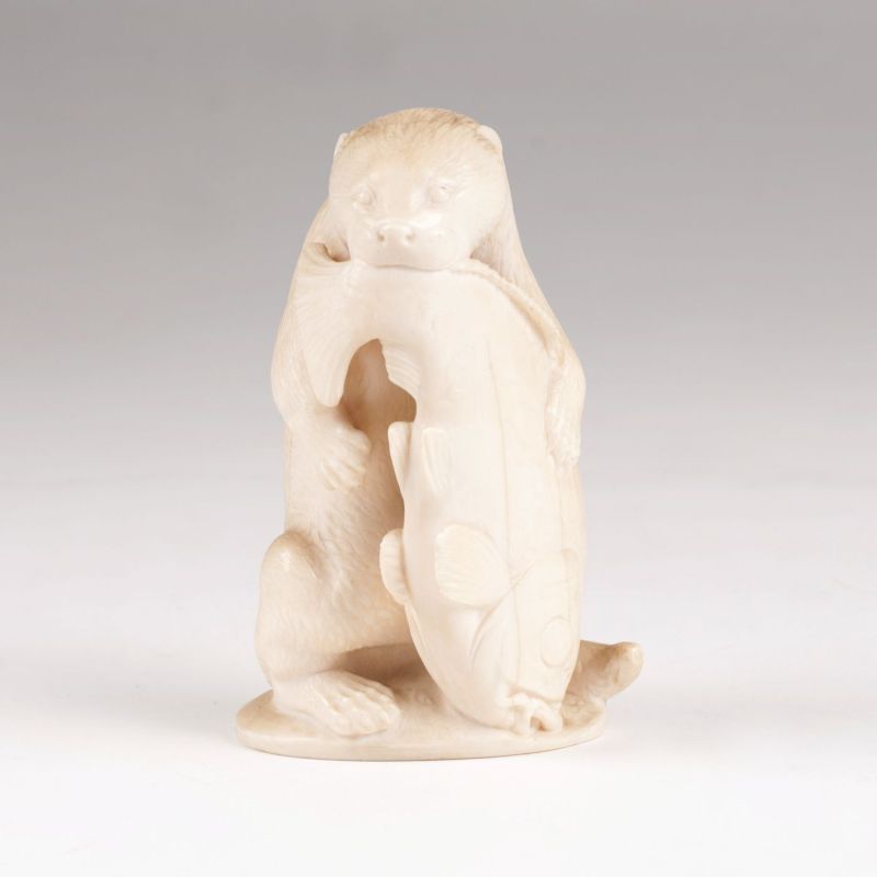 An ivory sculpture 'Otter and large  prey'