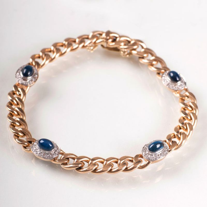 A curb chain bracelet with sapphire cabochons and diamonds