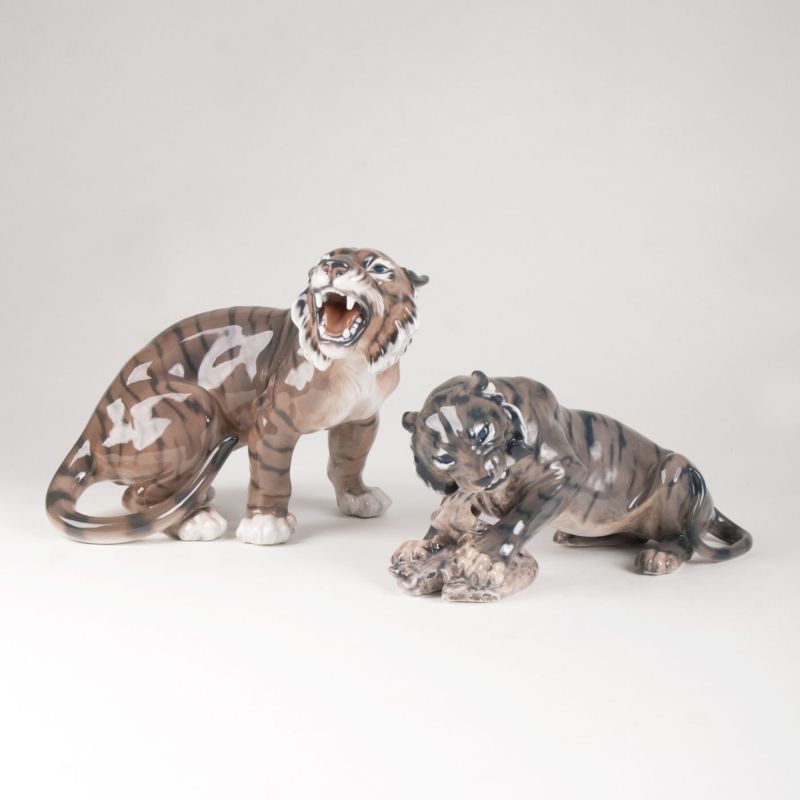 Zwei Porzellanfiguren 'Brüllender bzw. fressender Tiger'