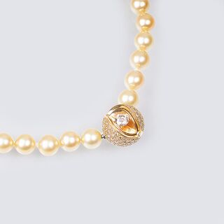 A Highcarat Solitaire Diamond Mystery Sphere Clasp on Pearl Necklace