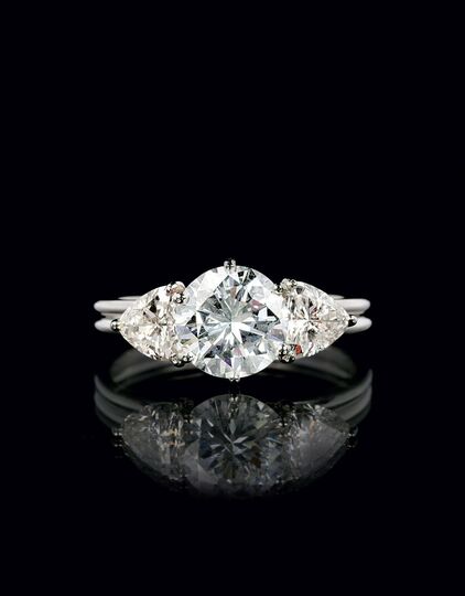 A Exceptional White Solitaire Diamond Ring with Triangle Diamonds