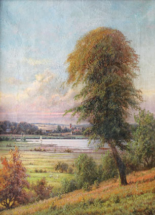 A landscape in Fünen with a lake and a village beyond