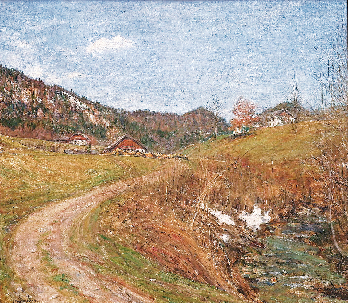 A view on a valley in early springtime with farmhouses and forest beyond