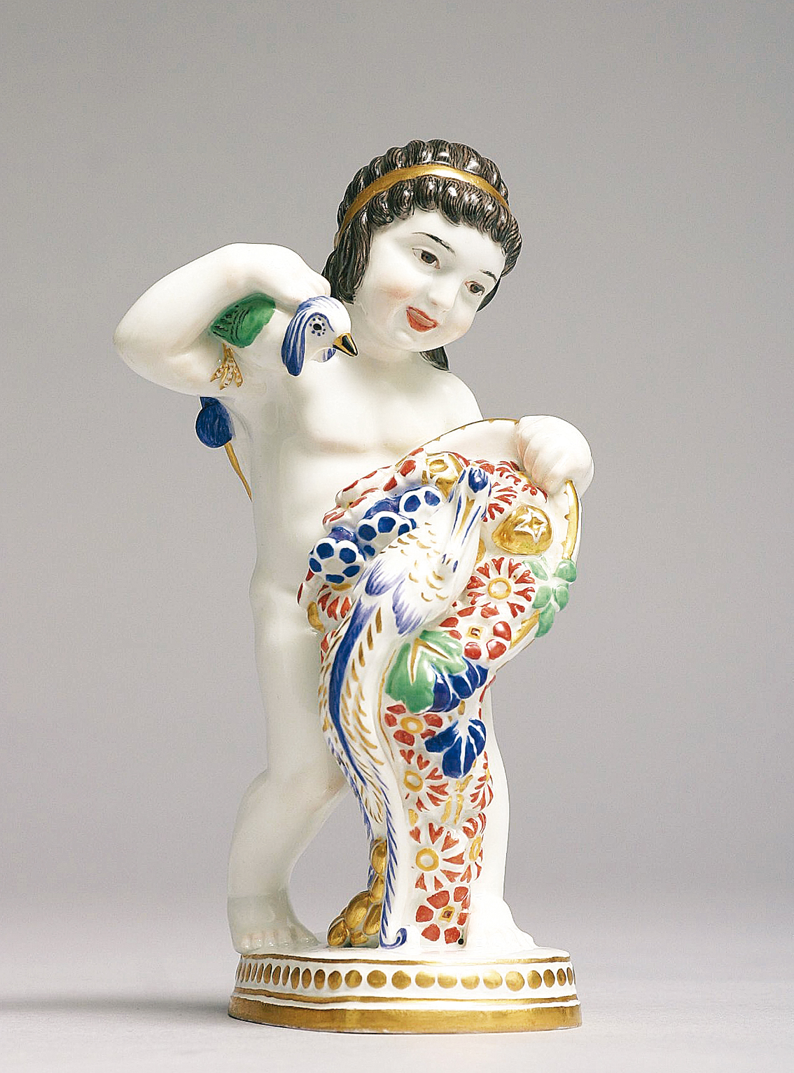 A rare art-nouveau figure of a putto with cornucopia and paradise birds