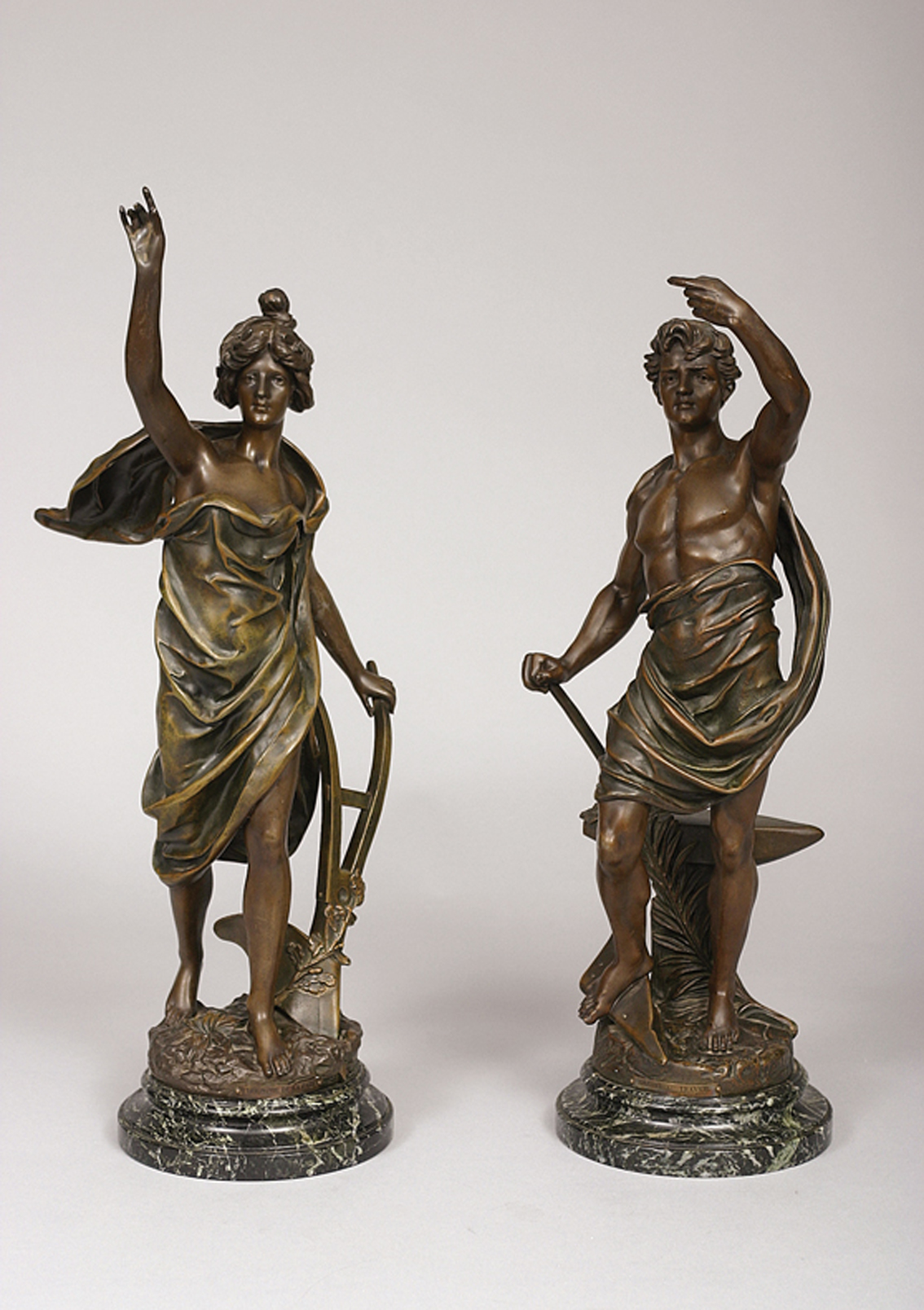A pair of french figures 'Glorie au Travail' and 'Triomphe de la Paix'