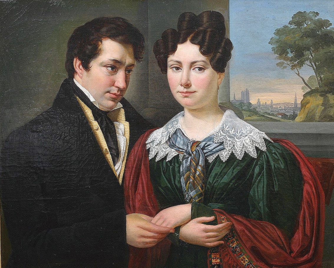 A young couple in front of a city