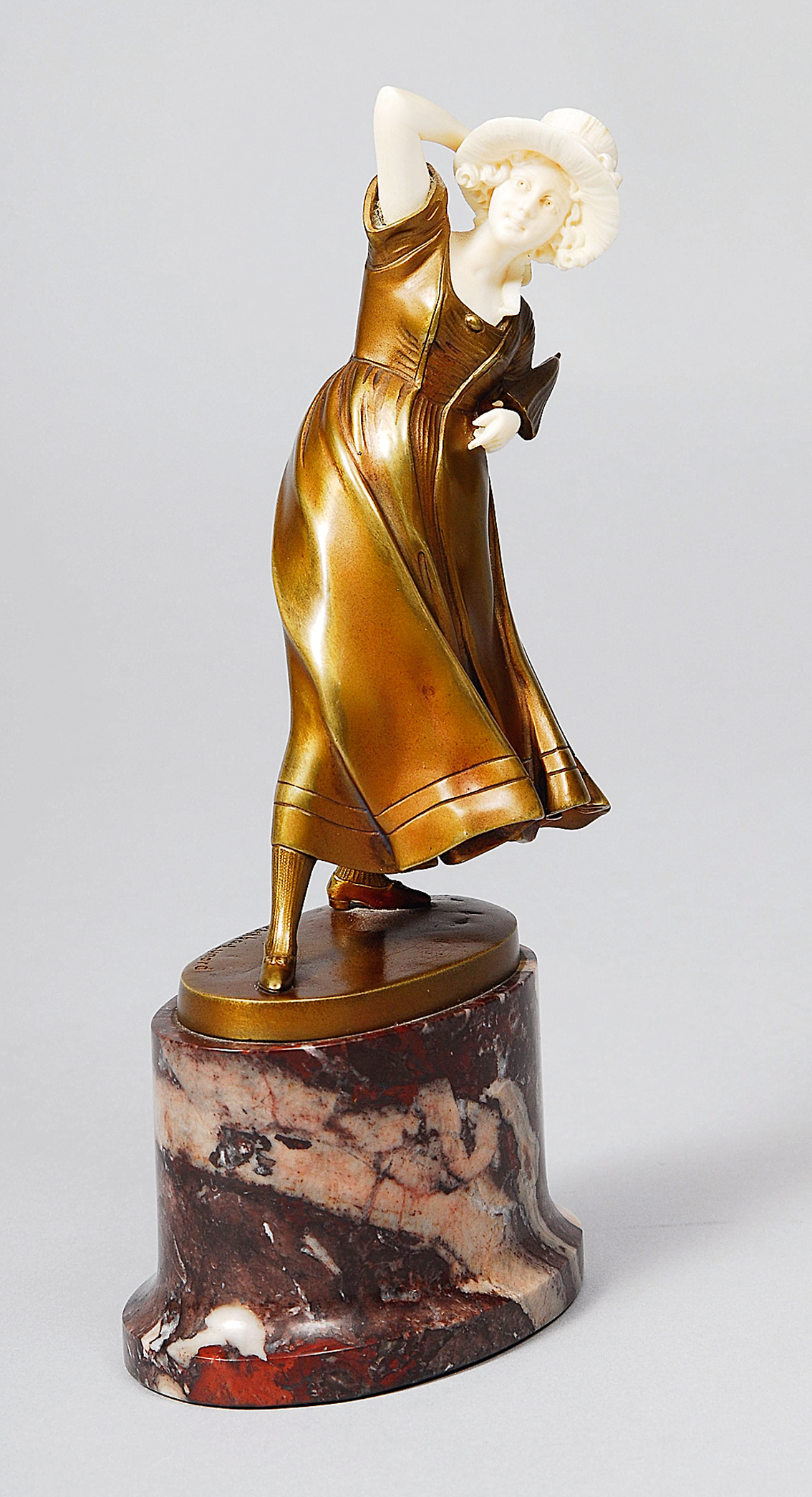 A small Art Nouveau Bronze 'Girl with hat'