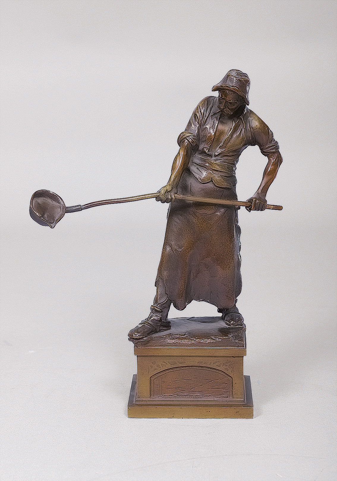 A small bronze figure 'Iron caster'