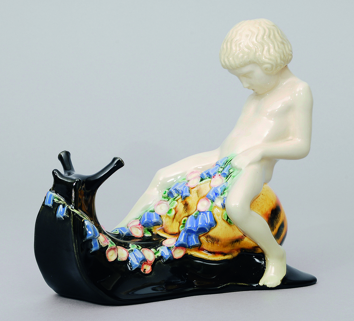 An art nouveau faience-figure of putto on a snail