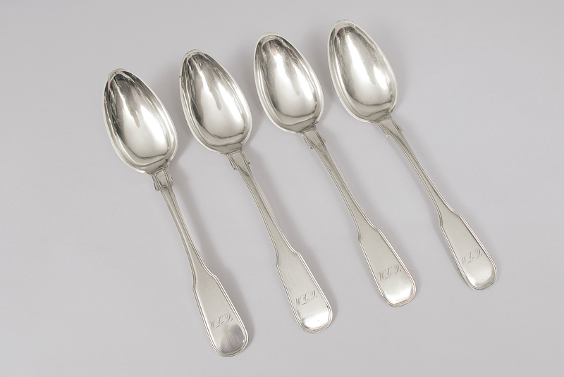 A convolute of four serving spoons