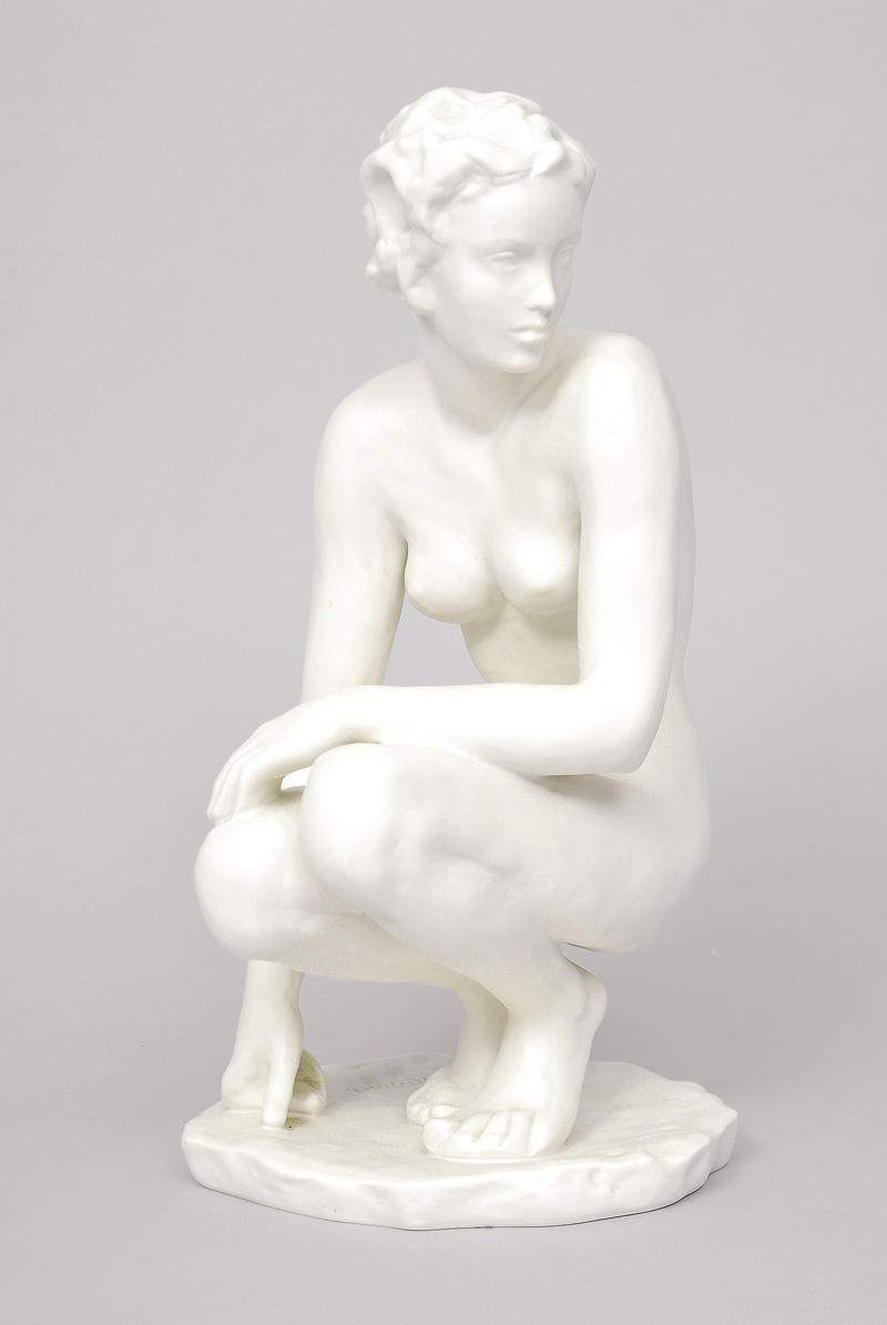 A figure of a croching nude in biscuit porcelain