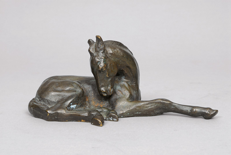 A small bronze figure 'Lying down foal'