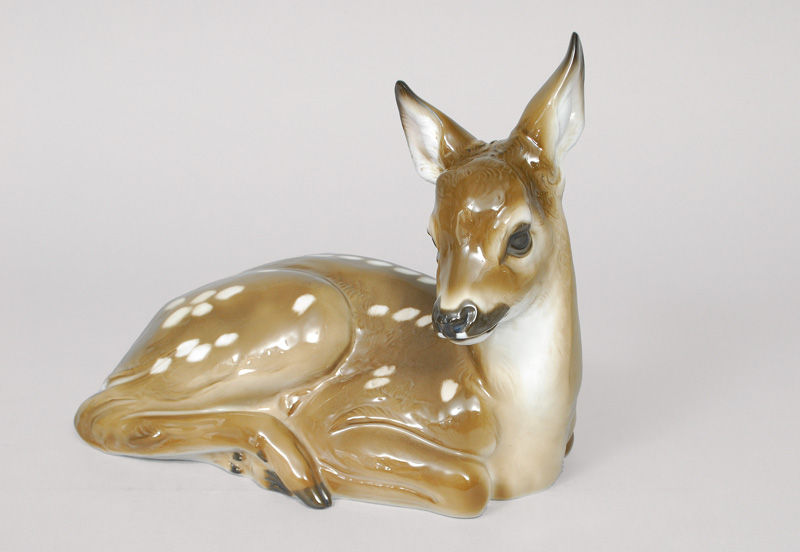 A big animal figurine 'lying fawn with raised head'