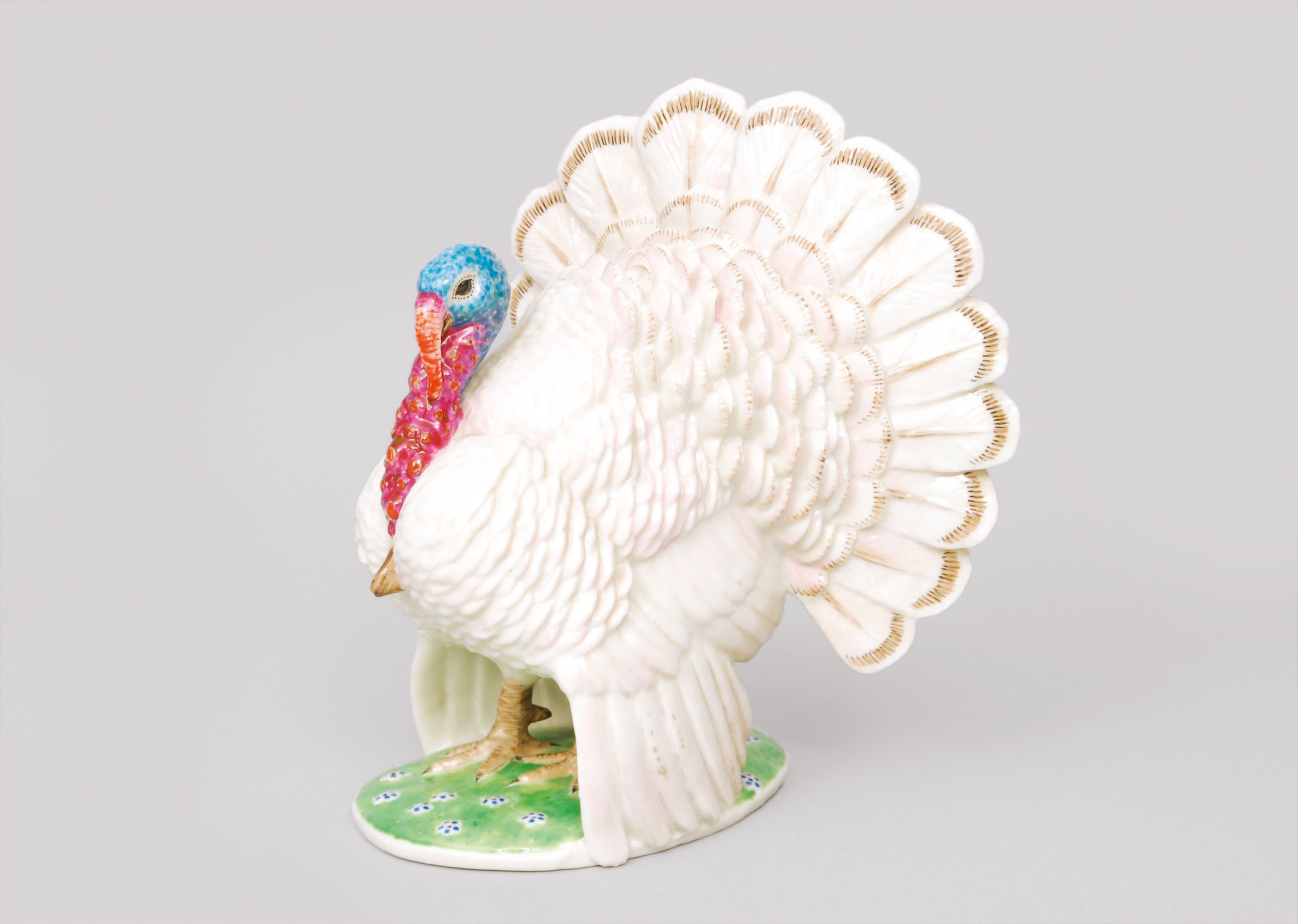 An animal figurine 'turkey' on grass base