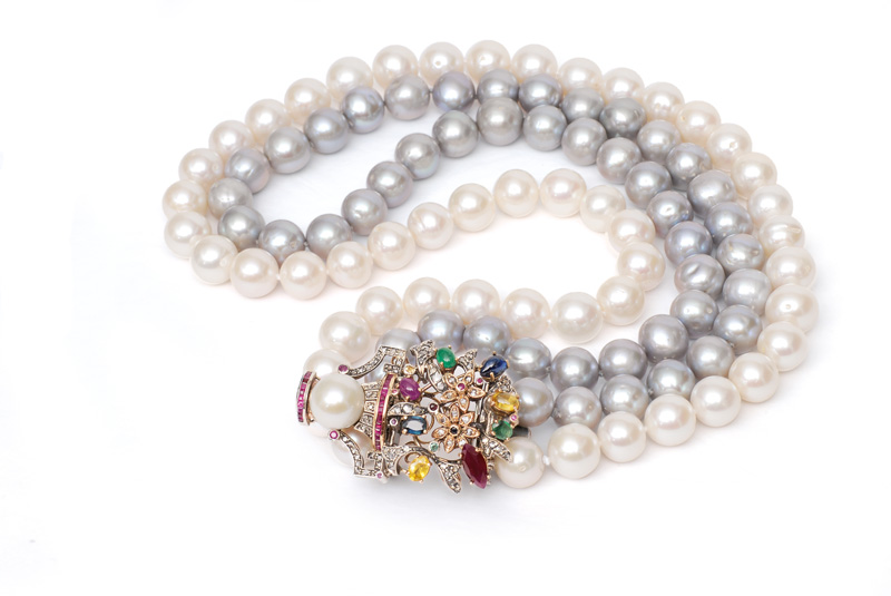 A pearl necklace with jewel-clasp