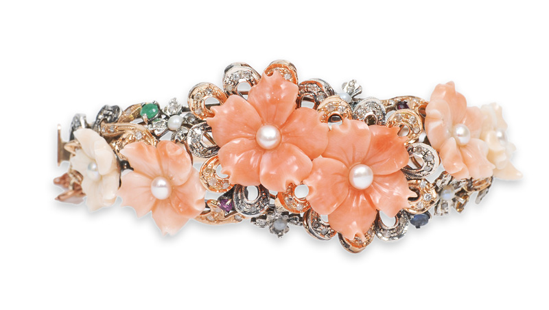 A fine coral diamond bangle bracelet with ornaments of flowers