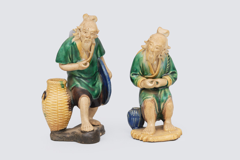 A pair of fisher figurines