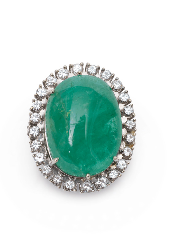 A large emerald cabochon diamond ring